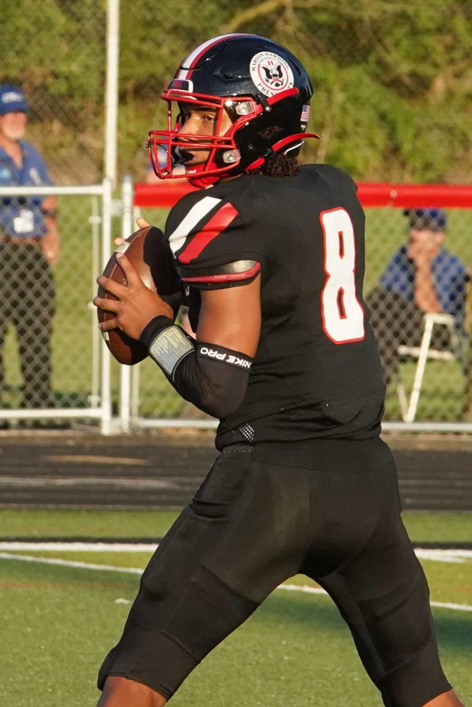 Marion Harding quarterback Alex Stokes drops back to pass during a season opening high school football game against Mount Vernon Friday night at Harding Stadium.