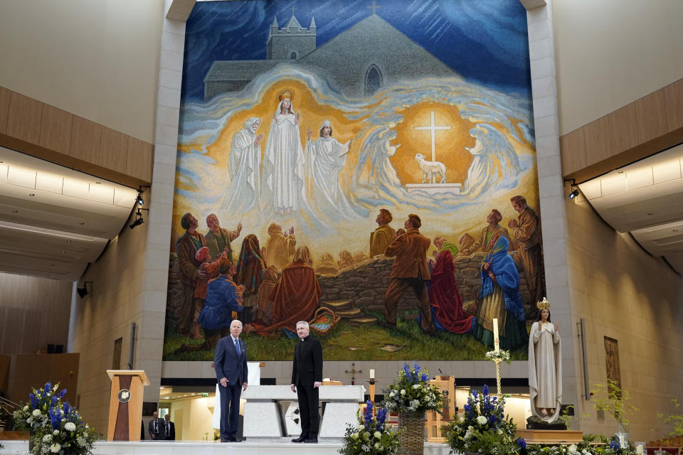 President Joe Biden stands with Father Richard Gibbons, parish priest and rector of Knock Shrine, as he tours Knock Shrine in Knock, Ireland, Friday, April 14, 2023. (AP Photo/Patrick Semansky)