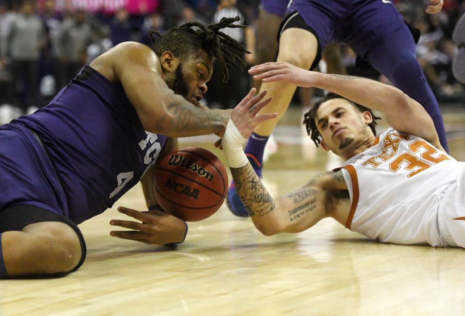 TCU's Eddie Lampkin Jr., left, and Texas' Christian Bishop fight for a loose rebound during Thursday's Big 12 Tournament quarterfinals at the T-Mobile Center in Kansas City, Mo. The Horned Frogs won 65-60.