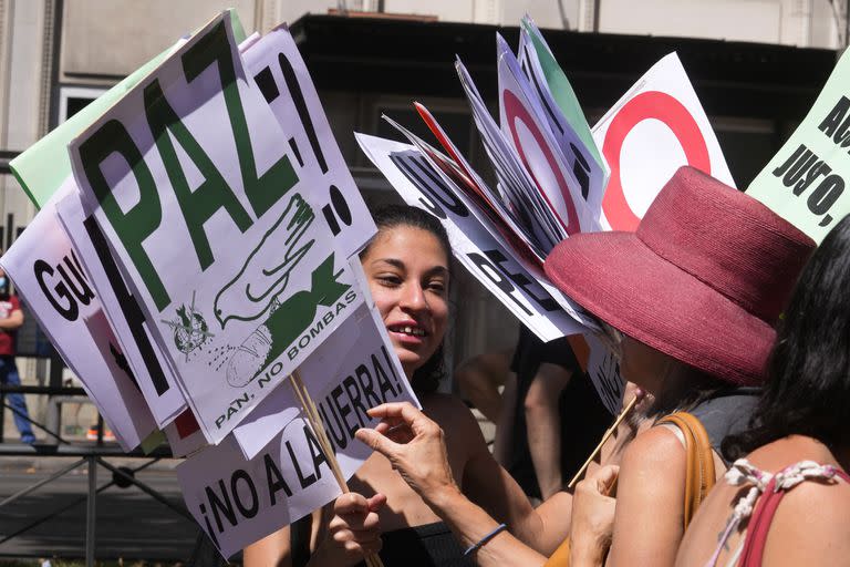 Un manifestante reparte pancartas durante una manifestación contra la OTAN antes de la Cumbre de la OTAN de 2022 en Madrid, España, el domingo 26 de junio de 2022. En la pancarta principal se lee "Paz. Pan, no bombas'.