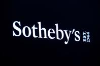 A screen shows the logo for Sotheby's on the floor at the NYSE in New York