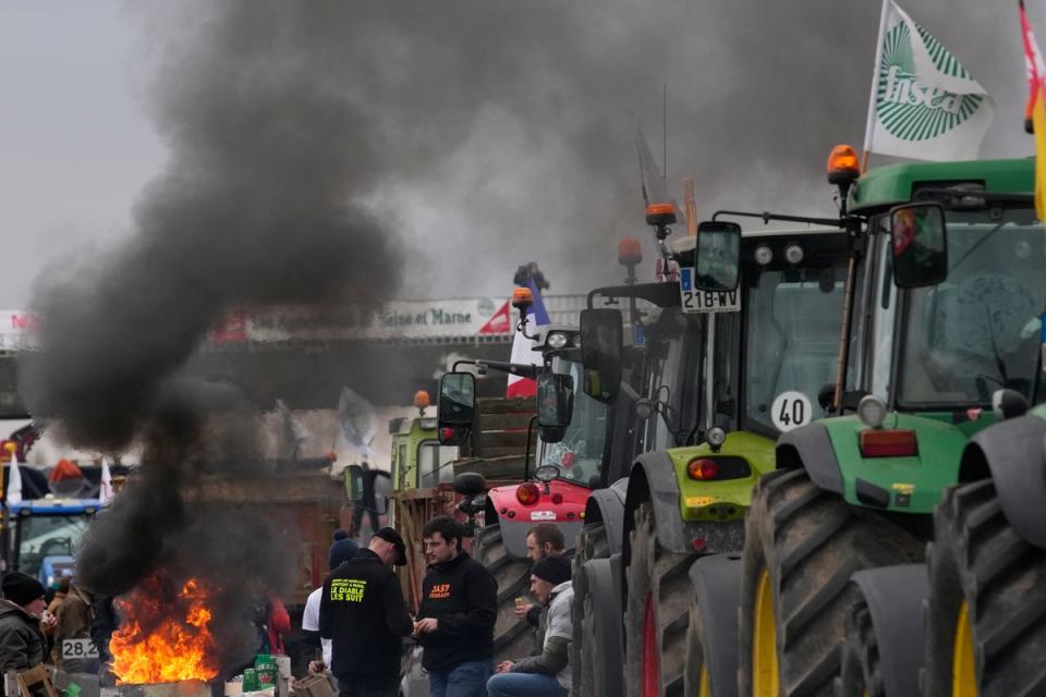 Farmers block a highway in Jossigny, east of Paris (AP)