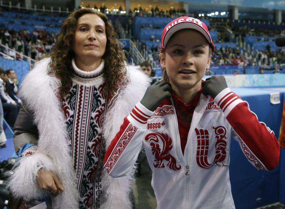 Julia Lipnitskaia of Russia, right, leaves the ice after competing in the women's team free skate figure skating competition at the Iceberg Skating Palace during the 2014 Winter Olympics, Sunday, Feb. 9, 2014, in Sochi, Russia. (AP Photo/Darron Cummings, Pool)