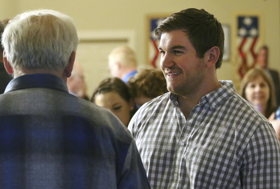 FILE - In this May 15, 2018 file photo, Alek Skarlatos, right, speaks at the Douglas County Republican Party headquarters in Roseburg, Ore. Skarlatos, who in 2015 helped thwart an attack by a gunman on a Paris-bound train, faces longtime Democratic U.S. Rep. Peter DeFazio in the November election. (Michael Sullivan/The News-Review via AP, File)