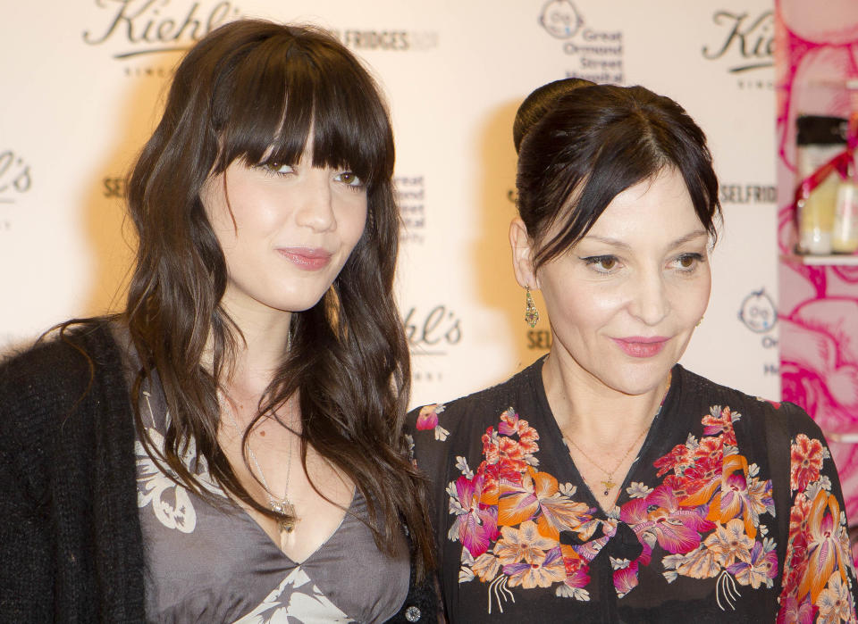 British Fashion designer Pearl Lowe, right and her daughter, British model Daisy Lowe pose for photographs before they sign bottles of their charity edition body cream, at a central London store, Thursday, March 15, 2012. Profits from each sale go towards the Great Ormond Street Hospital Children's Charity. (AP Photo/Joel Ryan)