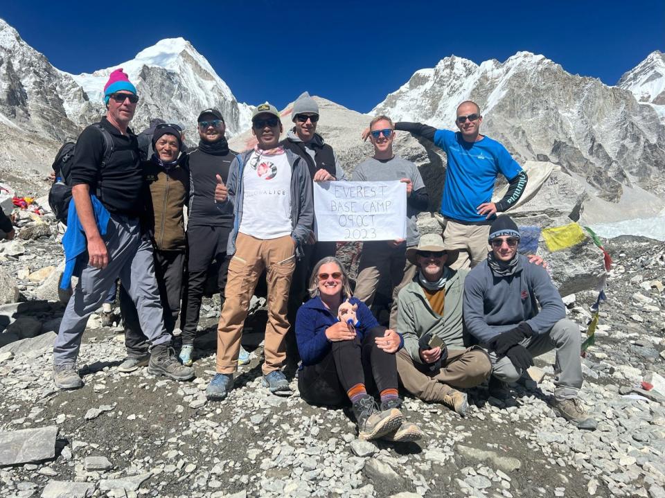 Green firefighter Josh Compton and members of his tour pose on Mount Everest. Compton traveled to a base camp on the world's highest peak, climbing to more than 17,000 feet.