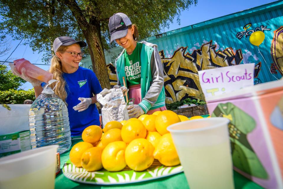 Sophia Trcka, left, and Emeleia McLauchlin, right, laugh as they make lemonade for their stand along the B-Line Trail on Lemonade Day in Monroe County on Saturday, June 18, 2022. 