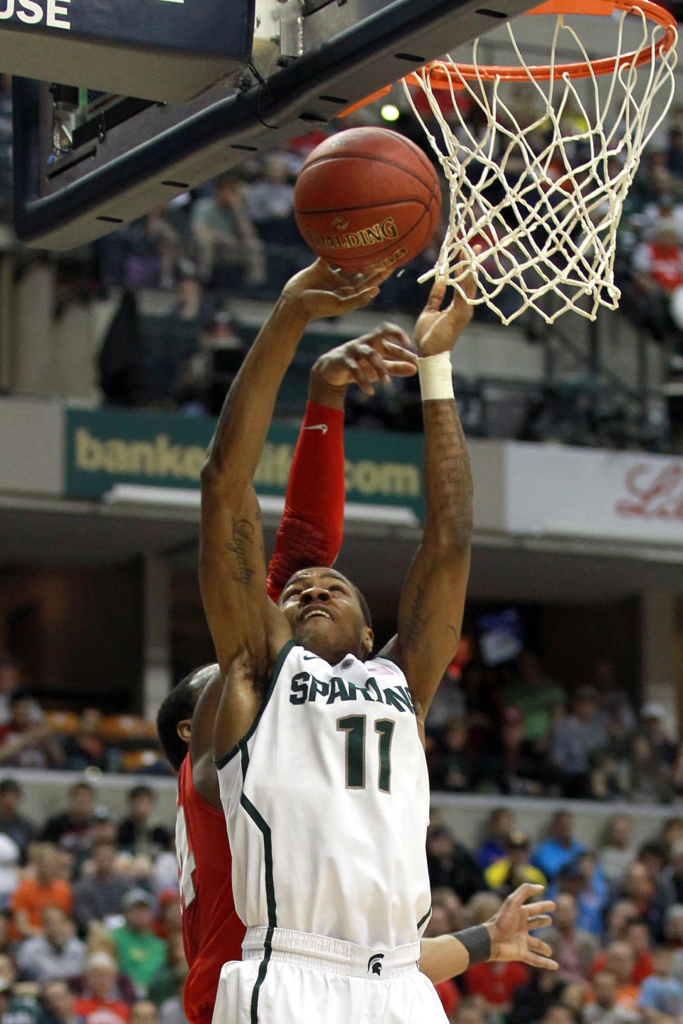 INDIANAPOLIS, IN - MARCH 11: Keith Appling #11 of the Michigan State Spartans attempts a shot against the Ohio State Buckeyes during the Final Game of the 2012 Big Ten Men's Conference Basketball Tournament at Bankers Life Fieldhouse on March 11, 2012 in Indianapolis, Indiana. (Photo by Andy Lyons/Getty Images)