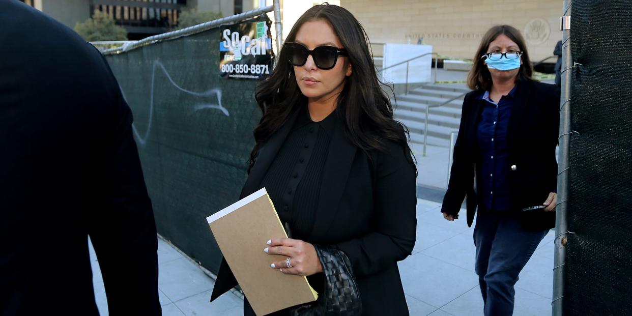 Vanessa Bryant dressed in black, wearing sunglasses and holding notepad