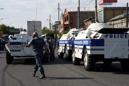 Policemen block a street after a group of armed men seized a police station along with an unknown number of hostages, according the country's security service, in Yerevan, Armenia, July 17, 2016. REUTERS/Melik Baghdasaryan/Photolure