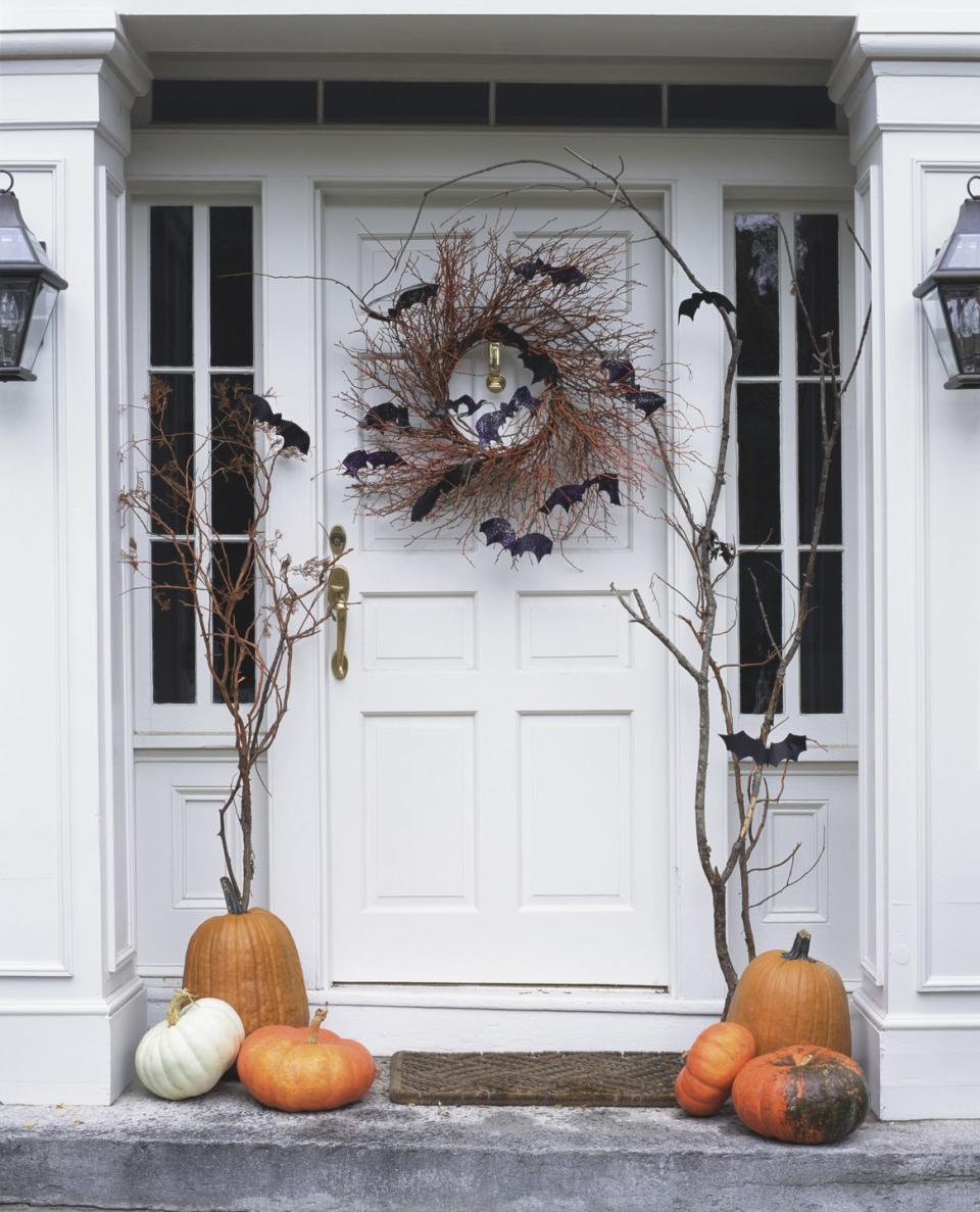 <p>It doesn't get easier than this: Simply add felt bats to a natural twig wreath to give trick-or-treaters a friendly fright. </p>