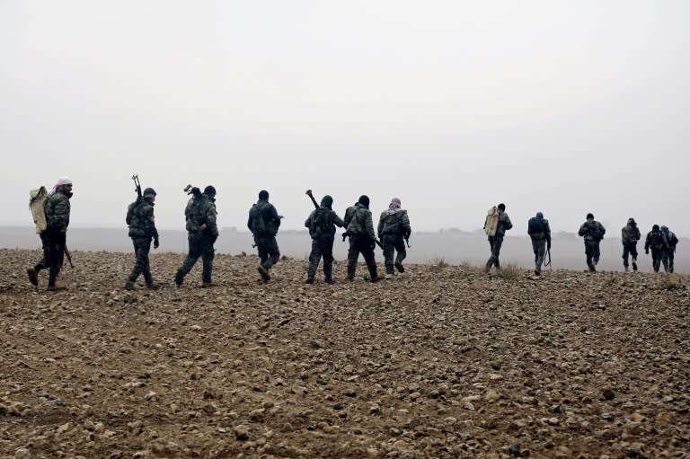 Fighters from the Kurdish-Arab alliance known as the Syrian Democratic Forces advance towards the Islamic State group bastion in Raqa in December 2016