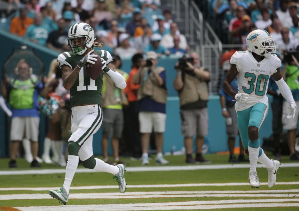 New York Jets wide receiver Robby Anderson hauls in a Josh McCown touchdown pass in Miami before jumping into the stands. (AP)