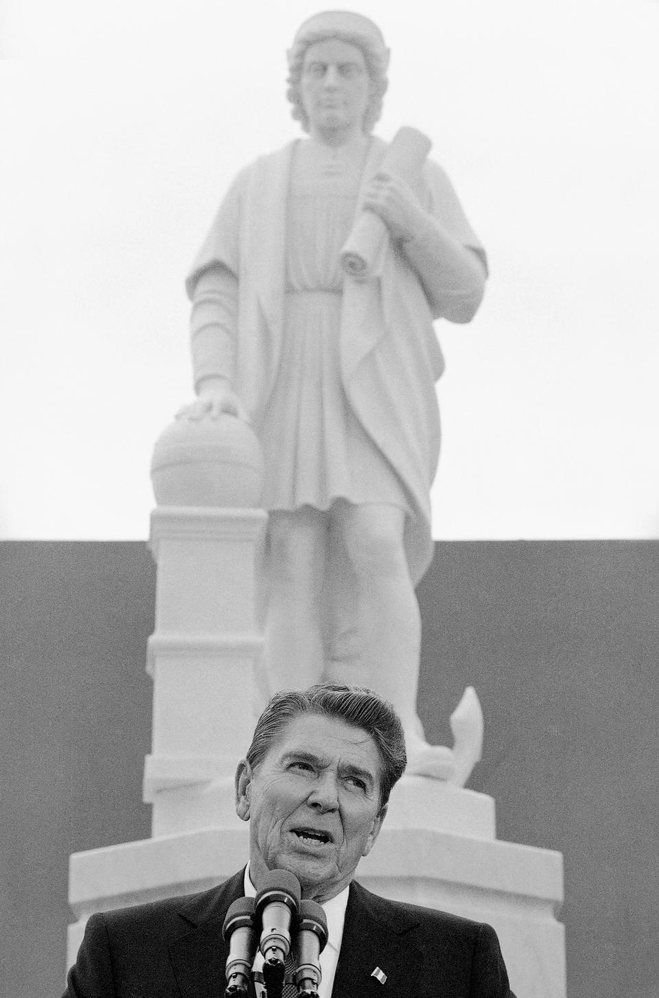 FILE - In this Monday, Oct. 9, 1984, file photo, President Ronald Reagan addresses a ceremony in Baltimore, to unveil a statue of Christopher Columbus. Pieces of the Christopher Columbus statue were retrieved from Baltimore’s Inner Harbor on Monday, July 6, 2020. WJZ-TV reports the recovery comes two days after protesters pulled down the figure from the Little Italy neighborhood and threw it into the harbor.(AP Photo/Lana Harris, File)