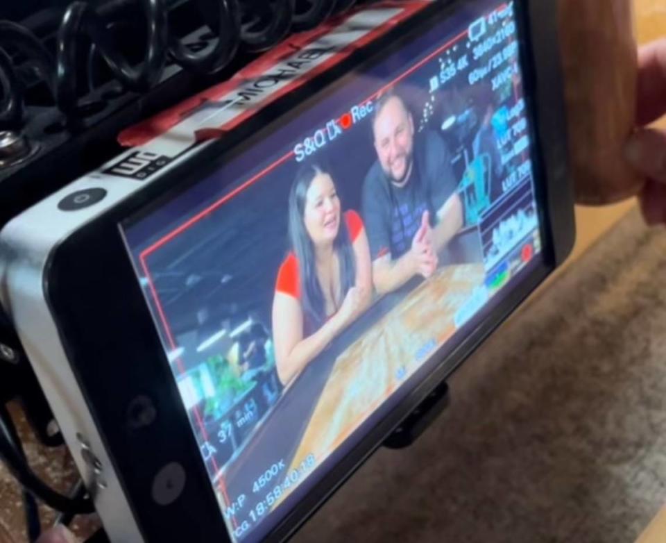 Salud owners Dairelyn and Jason Glunt are shown through camera equipment during the filming of “Que Delicia: El Sabor De America.”