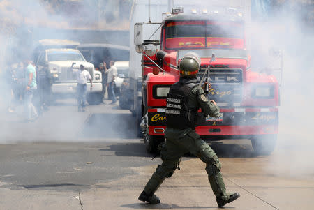 Lawmaker members of the Venezuelan National Assembly and supporters of the Venezuelan opposition leader Juan Guaido, who many nations have recognised as the country's rightful interim ruler, clash with security forces as they block the road on the outskirts of Mariara, Venezuela February 21, 2019. REUTERS/Andres Martinez Casares