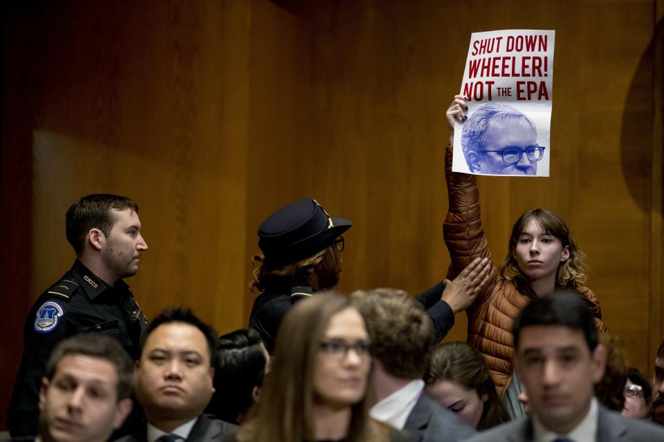 A protester is removed by Capitol police officers as Andrew Wheeler testifies at a Senate Environment and Public Works Committee hearing to be the administrator of the Environmental Protection Agency, on Capitol Hill in Washington, Wednesday, Jan. 16, 2019. (Photo: Andrew Harnik/AP)