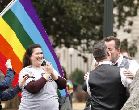 Greg and Roger kiss after getting married in a park outside the Jefferson County Courthouse in Birmingham, Alabama February 9, 2015. REUTERS/Marvin Gentry