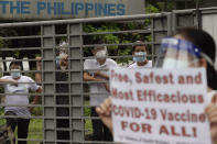 Health workers gather as they call on the government to give them a vaccine with the safest, highest efficacy and effectivity during a a protest outside the Lung Center of the Philippines in Quezon city, Philippines on Monday, March 1, 2021. The Philippines launched a vaccination campaign Monday to contain one of Southeast Asia's worst coronavirus outbreaks but faces supply problems and public resistance, which it hopes to ease by inoculating top officials. (AP Photo/Aaron Favila)