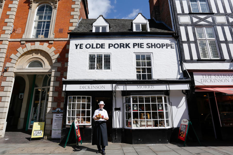 Stephen Hallam, of Dickinson and Morris, poses with a tray of Melton Mowbray Pork Pies outside Ye Olde Pork Pie Shop in Melton Mowbray (Luke MacGregor/Bloomberg via Getty Images)