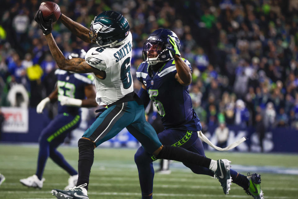 Dec 18, 2023; Seattle, Washington, USA; Philadelphia Eagles wide receiver DeVonta Smith (6) catches a pass against Seattle Seahawks safety Quandre Diggs (6, right) during the third quarter at Lumen Field. Mandatory Credit: Joe Nicholson-USA TODAY Sports
