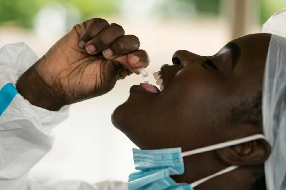 A health worker takes a cholera vaccine at the Bwaila Hospital in Lilongwe central Malawi