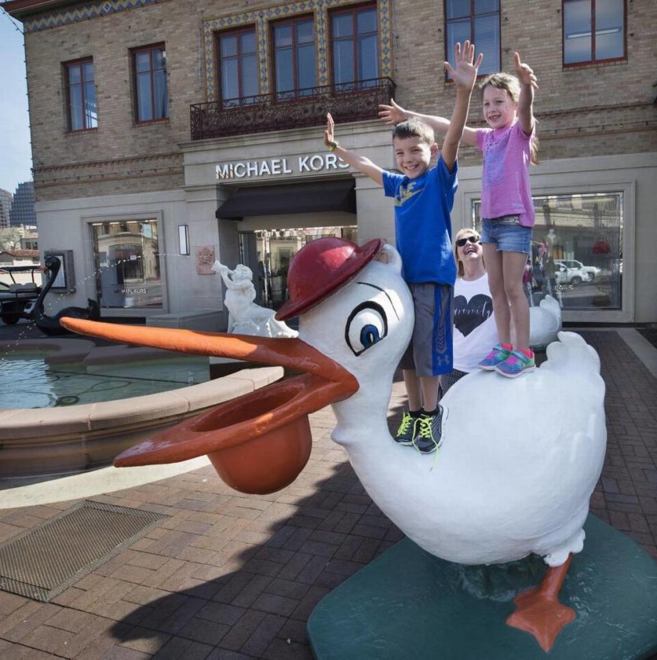 Brother and sister Max and Eva Ortiz of Peculiar, Mo., spread their wings on top of the newly displayed stork while their grandmother, Carole Lakey, keeps a close watch. “We knew the bunnies and animals were being put on display today,” she said, “so we brought the grandkids so they could enjoy the tradition.”