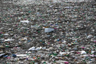 Plastic bottles and waste float at the Potpecko accumulation lake near Priboj, in southwest Serbia, Friday, Jan. 22, 2021. Serbia and other Balkan nations are virtually drowning in communal waste after decades of neglect and lack of efficient waste-management policies in the countries aspiring to join the European Union. (AP Photo/Darko Vojinovic)