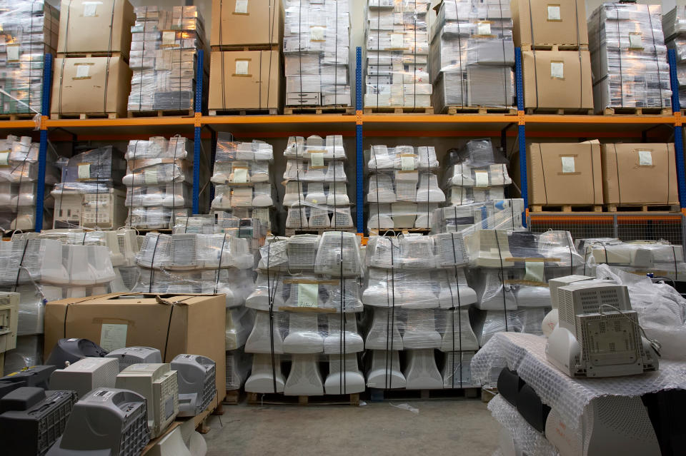 Warehouse full of computer parts system boxes monitors to be recycled or resold many in boxes or pallet wrapped