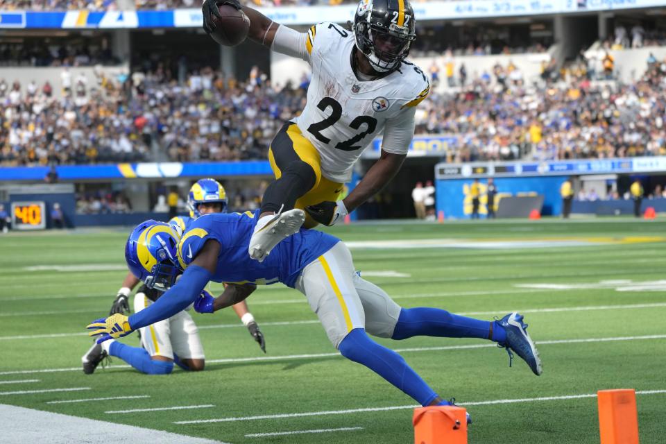 Pittsburgh Steelers running back Najee Harris (22) leaps over Los Angeles Rams safety Jordan Fuller.