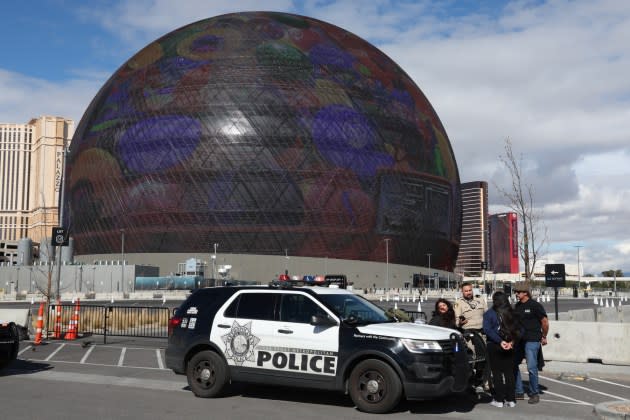 Individuals in handcuffs near the Sphere in Las Vegas after police responded to a man climbing the structure. - Credit: Jamie Squire/Getty Images