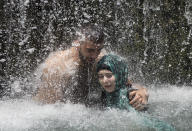 <p>Israeli Arabs stand under a waterfall during the Eid al-Fitr holiday at the Gan HaShlosha national park near the northern Israeli Town of Beit Shean, July 8, 2016. (Photo: Oded Balilty/AP) </p>