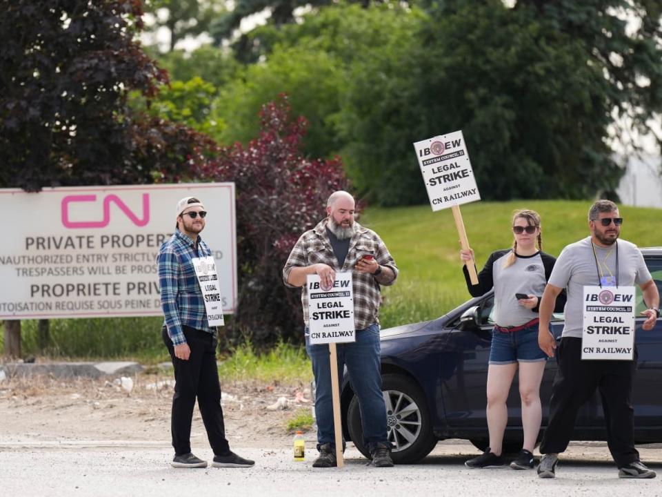 CN Rail workers strike at the CN MacMillan Yard in Vaughan, Ont., on Monday, June 20, 2022. (Nathan Denette/The Canadian Press - image credit)