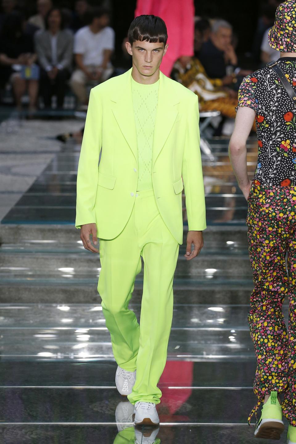 Blake Lively stepped out wearing a monochromatic neon-green suit from the SS'19 Versace menswear collection.
