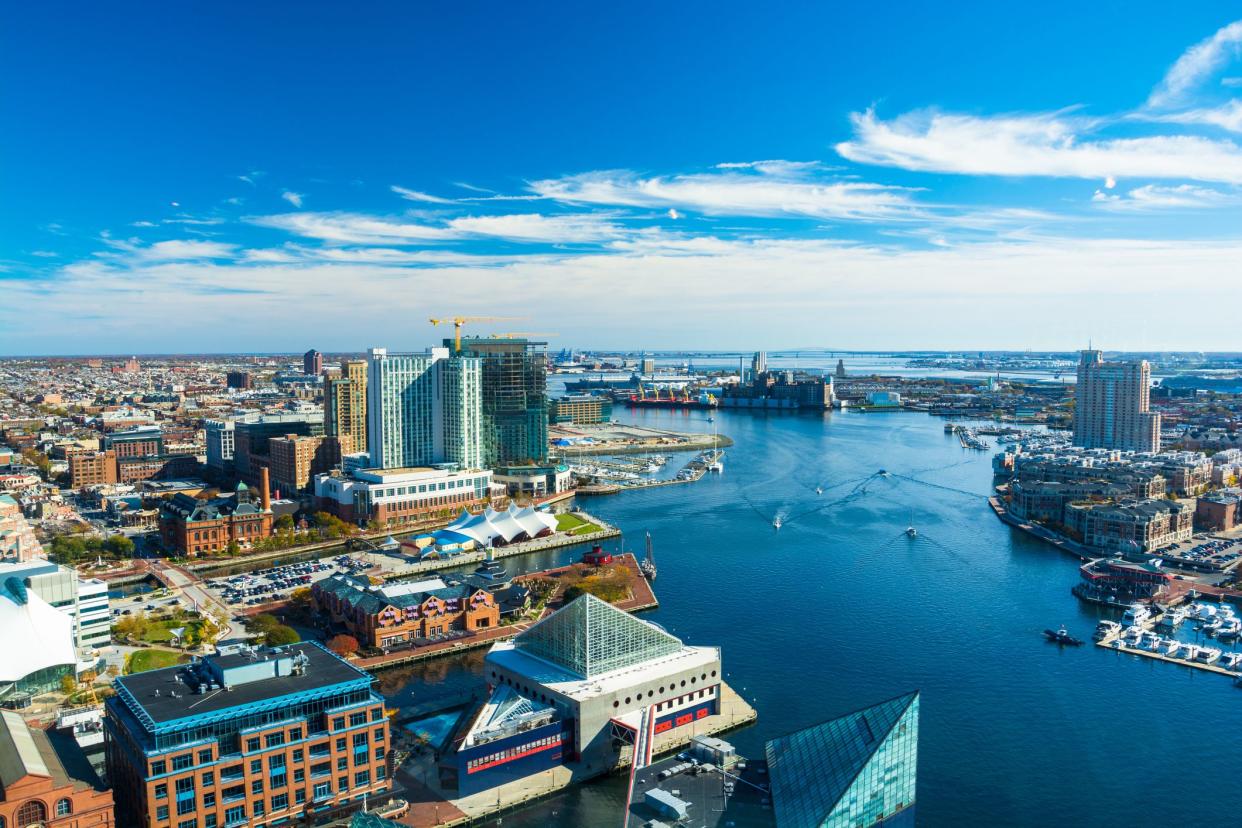 Aerial of Baltimore City with the Patapsco River and waterfront buildings.  Harbor East and Fells Point neighborhoods is shown on the left and the Tide Point neighborhood is shown on the right.