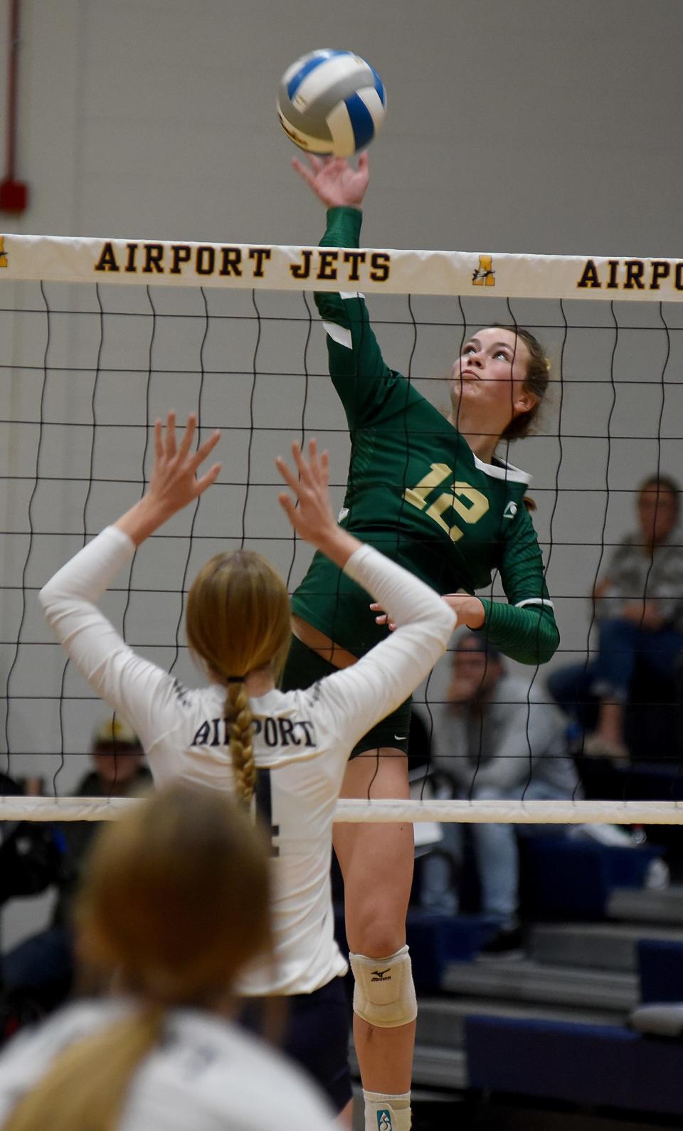 Jessica Costlow of St. Mary Catholic Central spike the ball against Airport in the Huron League Tournament.