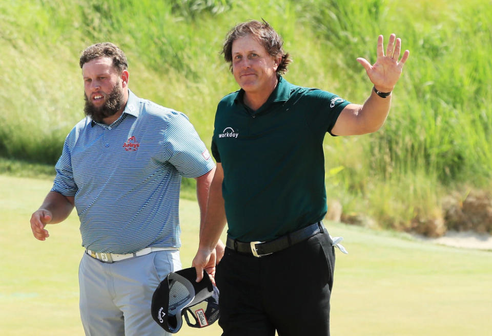 Phil Mickelson waves to the crowd after his bizarre Round 3 at the U.S. Open. (Getty)