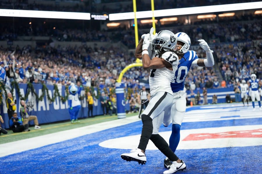Las Vegas Raiders wide receiver Davante Adams (17) makes a touchdown catch past Indianapolis Colts cornerback Jaylon Jones during the second half of an NFL football game Sunday, Dec. 31, 2023, in Indianapolis. (AP Photo/AJ Mast)