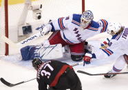 Carolina Hurricanes right wing Andrei Svechnikov (37) scores his third goal of the game past New York Rangers goaltender Henrik Lundqvist (30) as defenseman Jacob Trouba (8) tries to help out durng the third period of an NHL Stanley Cup playoff hockey game in Toronto, Monday, Aug. 3, 2020. (Frank Gunn/The Canadian Press via AP)