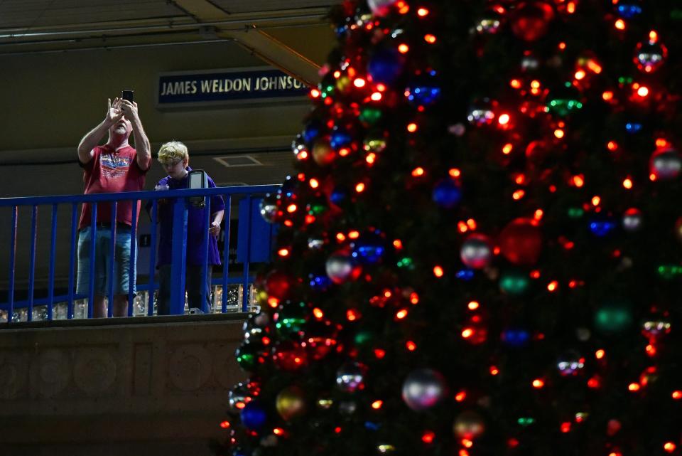 Spectators take in the lighted City of Jacksonville Christmas Tree from the James Weldon Johnson Park Skyway station in 2022.