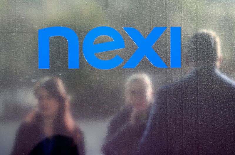 FILE PHOTO: People stand outside the Italian payments group Nexi's headquarters in Milan in Milan