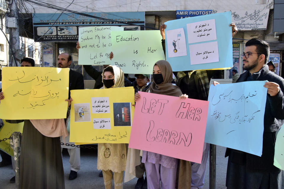 Afghan university students chant slogans and hold placards during a protest against the ban on university education for women, in Quetta, Pakistan, Saturday, Dec. 24, 2022. (AP Photo/Arshad Butt)
