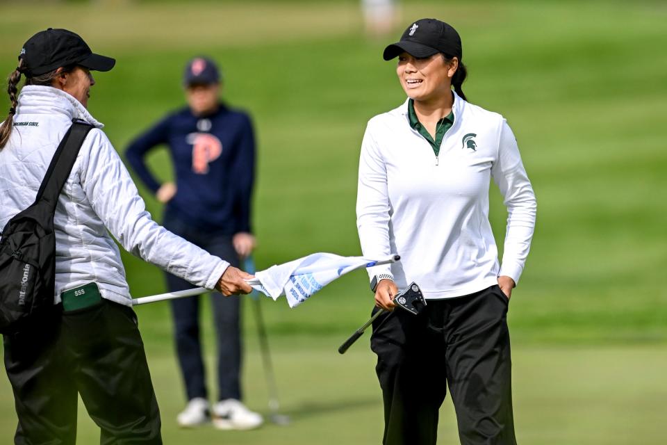 Michigan State's Katie Lu, right, talks with head coach Stacy Slobodnik-Stoll after finishing on the 10th hole on Monday, May 6, 2024, during the NCAA women's golf regional at Forest Akers West Golf Course in East Lansing.