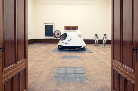 A twice-flown Soviet-era VA space capsule and a pair of Russian spacesuits are displayed at a Belgian gallery prior to their sale by Lempertz auction house on May 7, 2014.