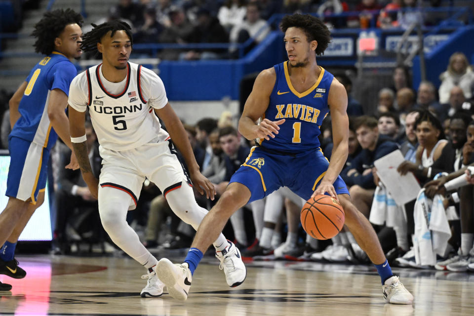 Xavier guard Desmond Claude (1) is guarded by UConn guard Stephon Castle (5) in the first half of an NCAA college basketball game, Sunday, Jan. 28, 2024, in Hartford, Conn. (AP Photo/Jessica Hill)