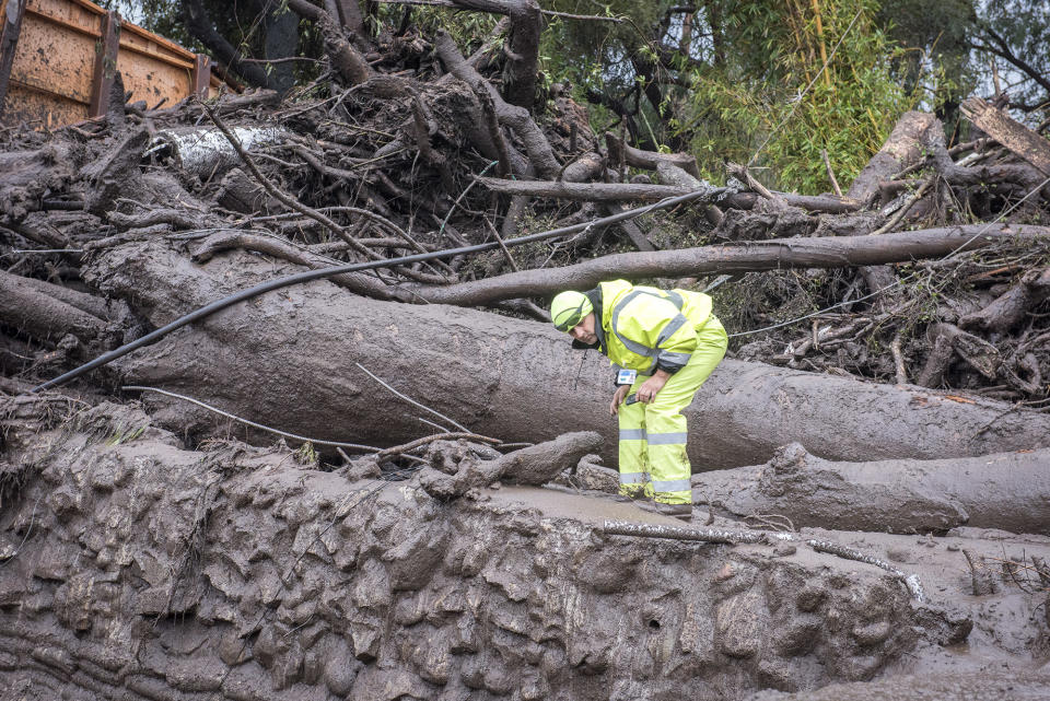 <p>Cesar Limon of the Montecito Water Dristrict surveys the area of Montecito Creek where flash flooding destroyed homes in Montecito, Calif., on Jan.9, 2018. (Photo: Erick Madrid via ZUMA Wire) </p>