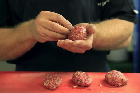 A chef prepares "Kibbeh", also known as Syrian meatballs, in the kitchen of the Castro restaurant in Budapest, Hungary, September 29, 2015. REUTERS/Bernadett Szabo