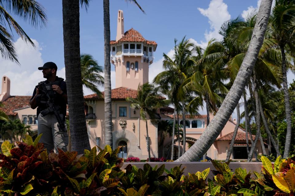 A security guard stands on the perimeter of former President Donald Trump's Mar-a-Lago home, Monday, April 3, 2023, in Palm Beach, Fla.