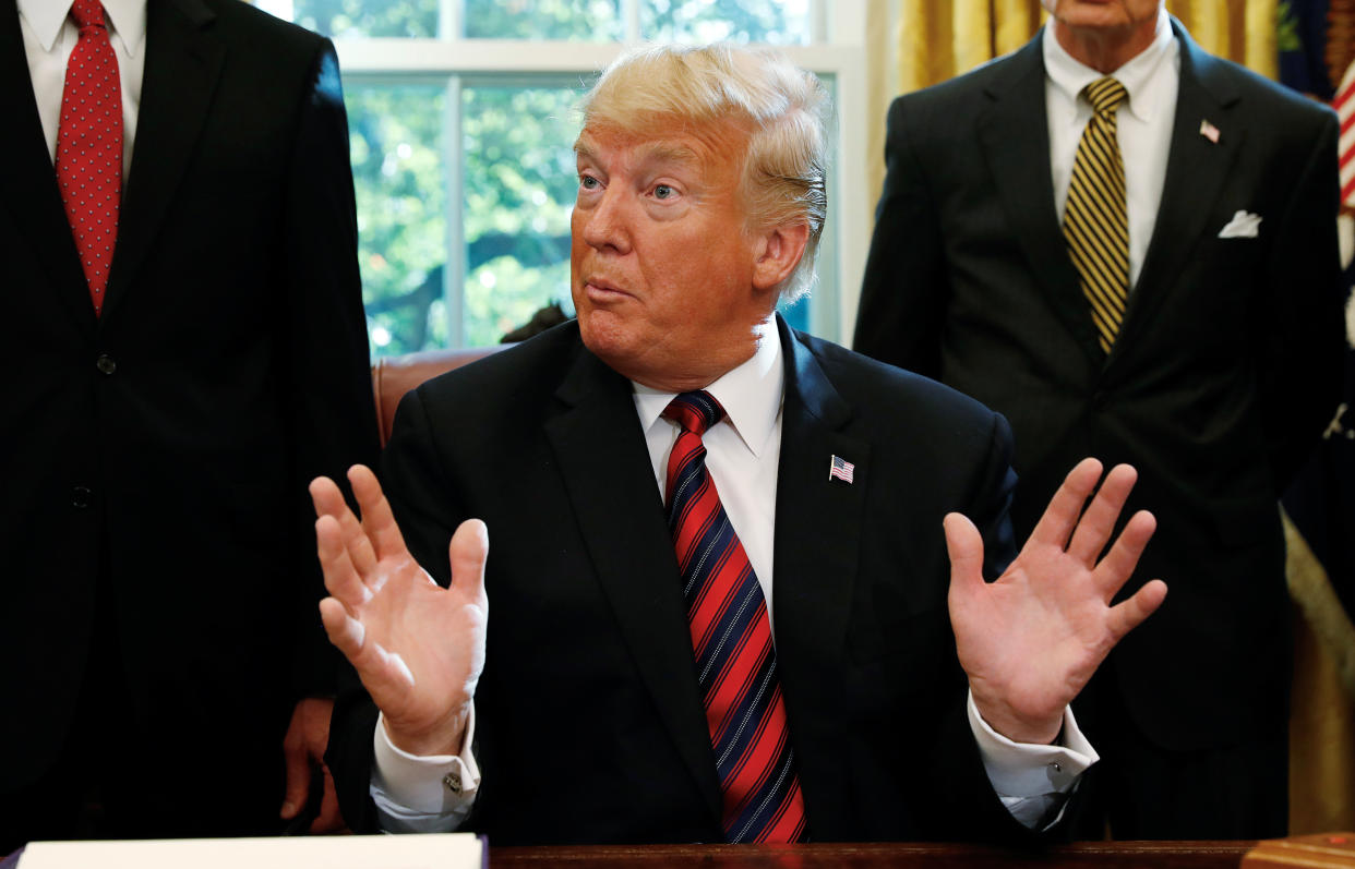 President Donald Trump talks to reporters about the killing of journalist Jamal Khashoggi in Turkey during a bill signing ceremony  at the White House in Washington on October 23, 2018. (Leah Millis/Reuters)