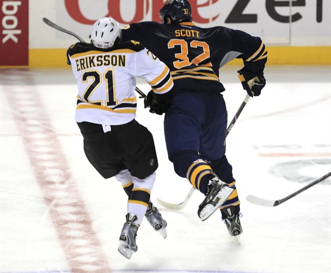 Buffalo Sabres John Scott (32) checks Boston Bruins Loui Eriksson (21) during third period action at the First Niagara Center in Buffalo on Wednesday, Oct. 23, 2013. Scott has been suspended indefinitely by the NHL pending a disciplinary hearing for a blindside hit to the head that levelled Eriksson. THE CANADIAN PRESS/AP/,Harry Scull Jr./Buffalo News